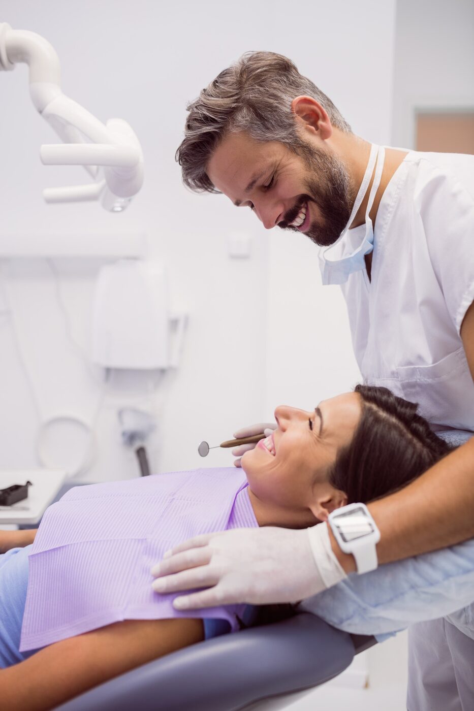 Dentist treating a smiling patient